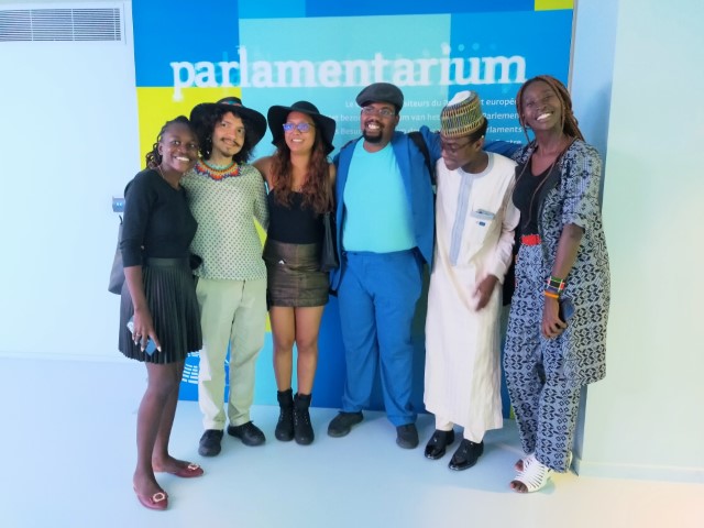 A group of young leaders posing together at the Parlamentarium in Brussels