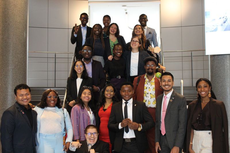 A group of young leaders posing together on a staircase at an EU meeting